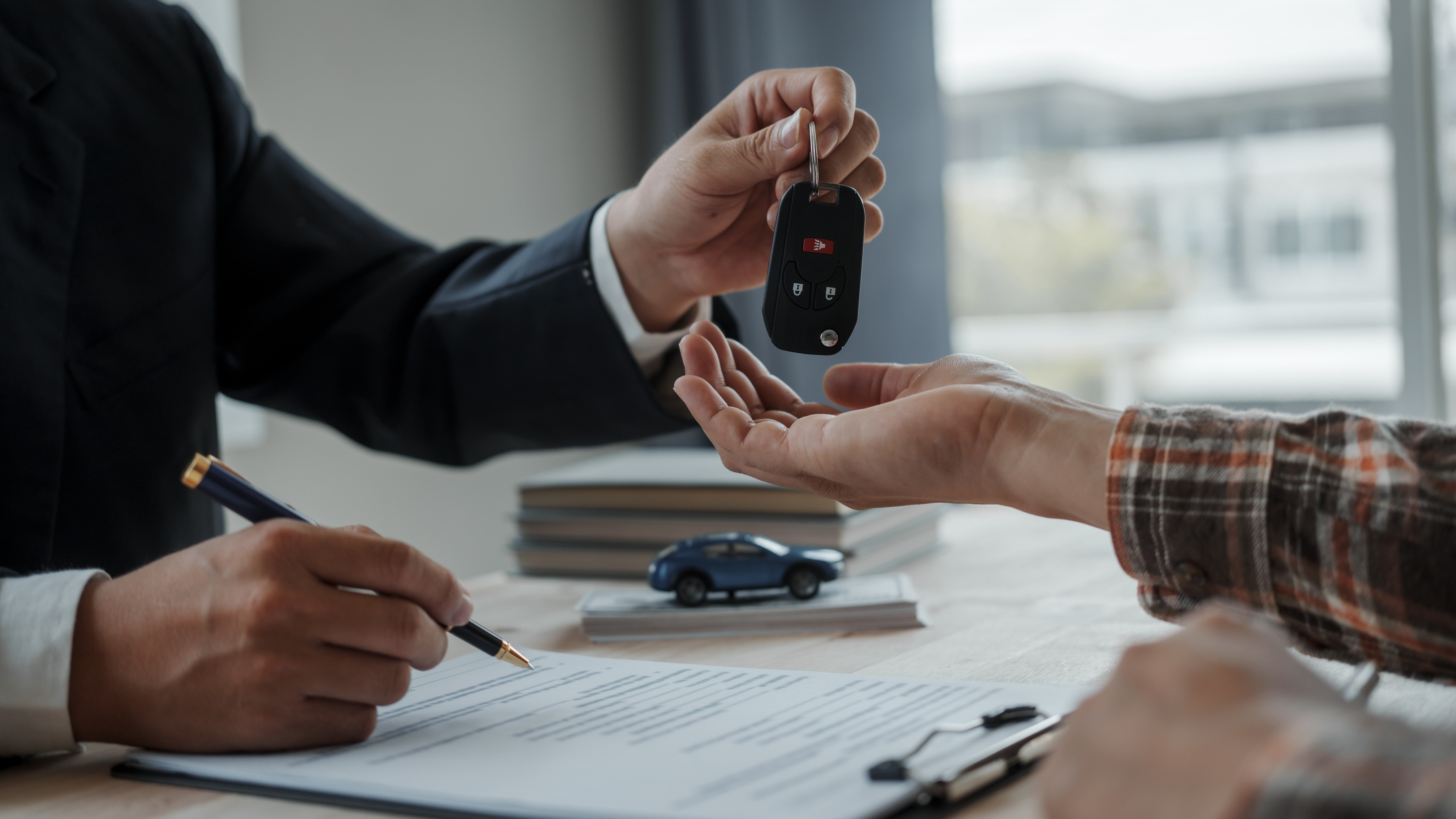 Chevrolet buyer signing auto loan paperwork to finance a new vehicle