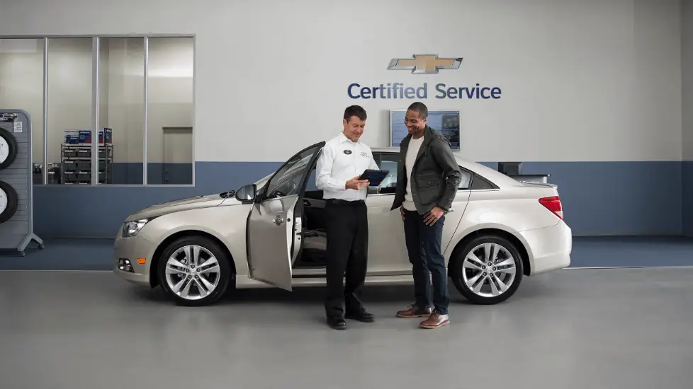 A service tehcnician going over a clipboard with a customer