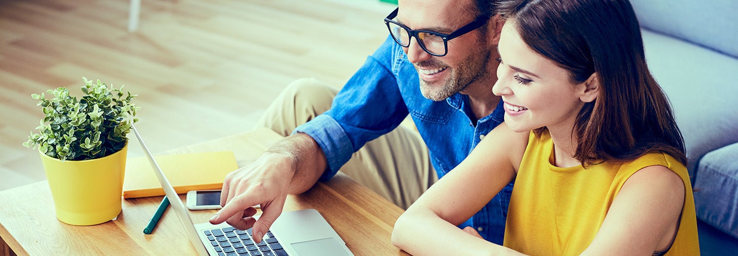 A man and woman on a laptop